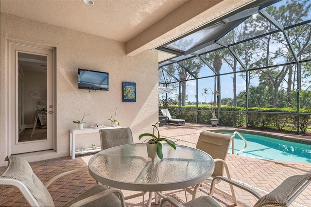 exterior space with glass enclosure and a patio area