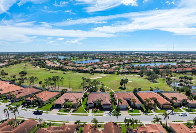 bird's eye view with view of golf course, a water view, and a residential view