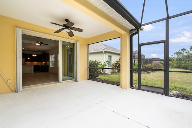 unfurnished sunroom featuring a ceiling fan