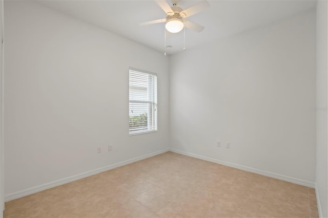 spare room featuring ceiling fan and baseboards