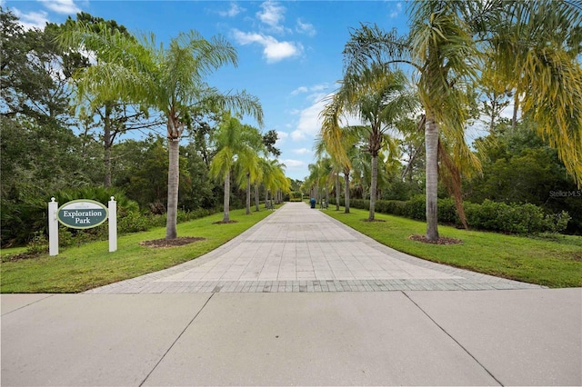 view of property's community featuring a yard