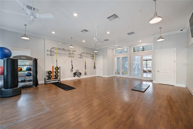 exercise area with ornamental molding, visible vents, and dark wood-type flooring