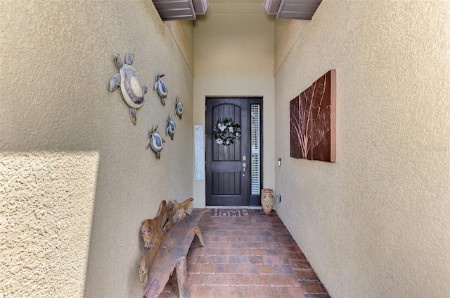 view of exterior entry with stucco siding