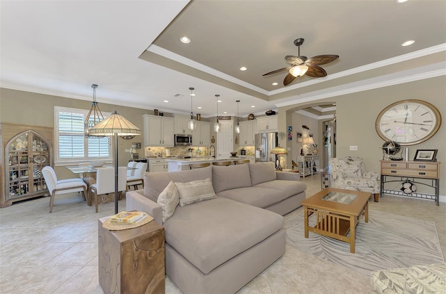 living room featuring recessed lighting, a raised ceiling, crown molding, and light tile patterned floors