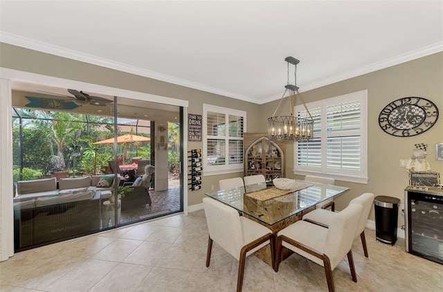 dining area featuring tile patterned flooring, ornamental molding, baseboards, and ceiling fan with notable chandelier