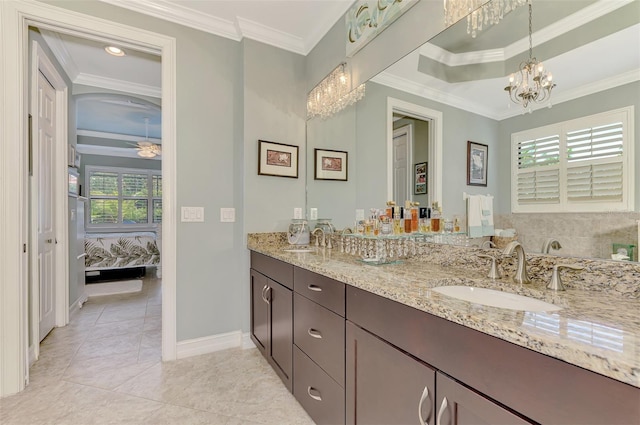 ensuite bathroom with ensuite bath, ornamental molding, a sink, and ceiling fan with notable chandelier