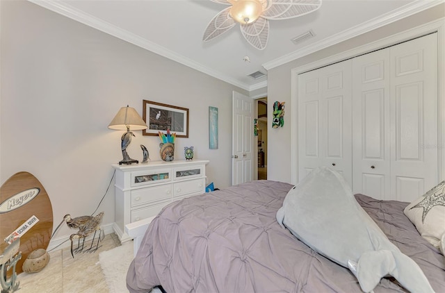 tiled bedroom with baseboards, a closet, visible vents, and crown molding