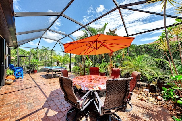 view of patio with glass enclosure and outdoor dining area