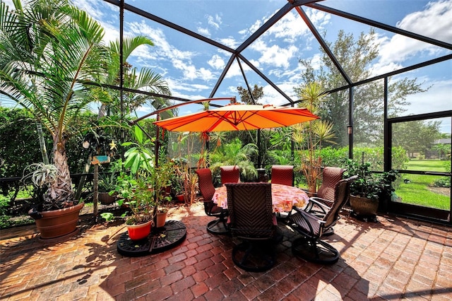 view of patio with glass enclosure and outdoor dining space