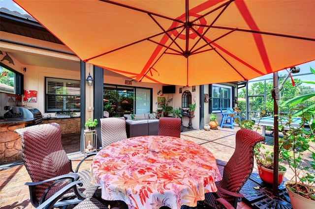 view of patio featuring outdoor lounge area, an outdoor kitchen, and outdoor dining space