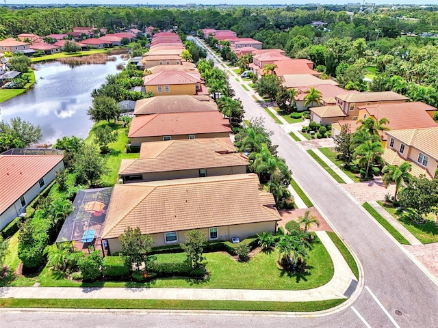 birds eye view of property with a water view and a residential view