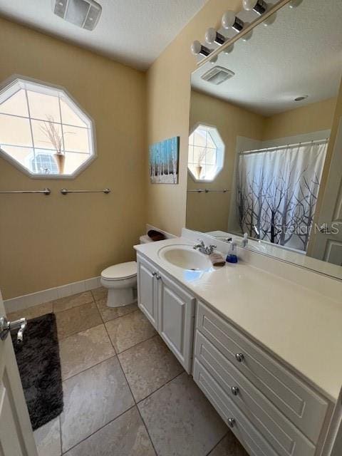 full bathroom with toilet, baseboards, visible vents, and vanity