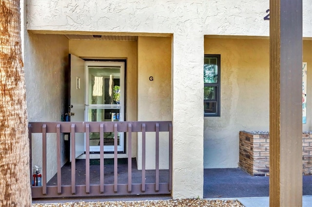 entrance to property with stucco siding