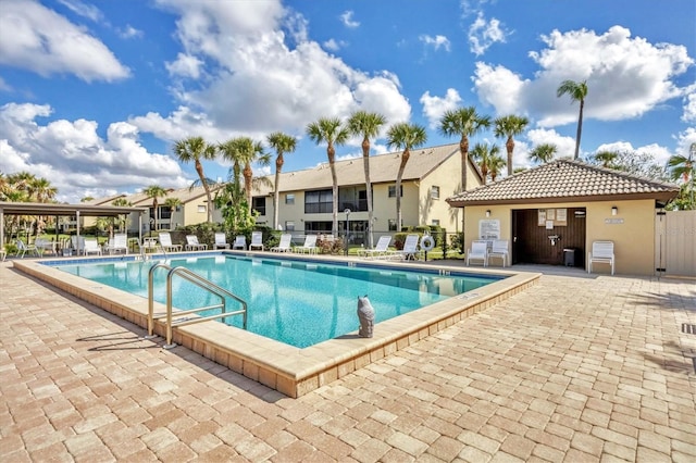 pool featuring fence and a patio