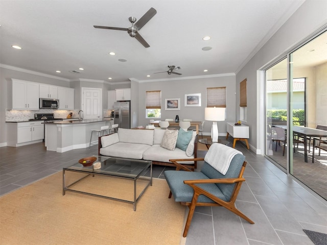 tiled living room featuring recessed lighting, crown molding, and baseboards