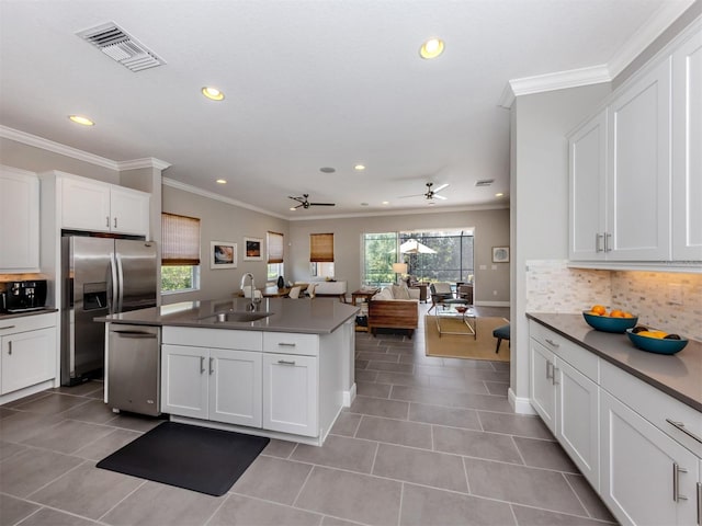 kitchen featuring appliances with stainless steel finishes, plenty of natural light, visible vents, and a sink