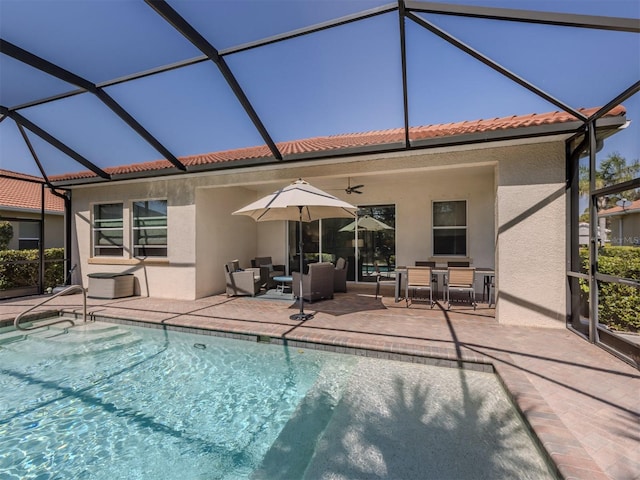 outdoor pool with an outdoor hangout area, ceiling fan, a patio area, and a lanai