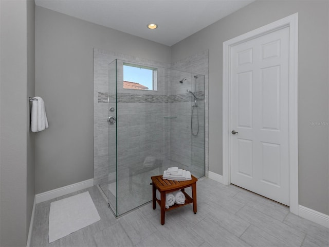 full bathroom featuring baseboards and walk in shower