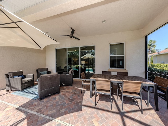 view of patio with outdoor dining area, an outdoor living space, and a ceiling fan