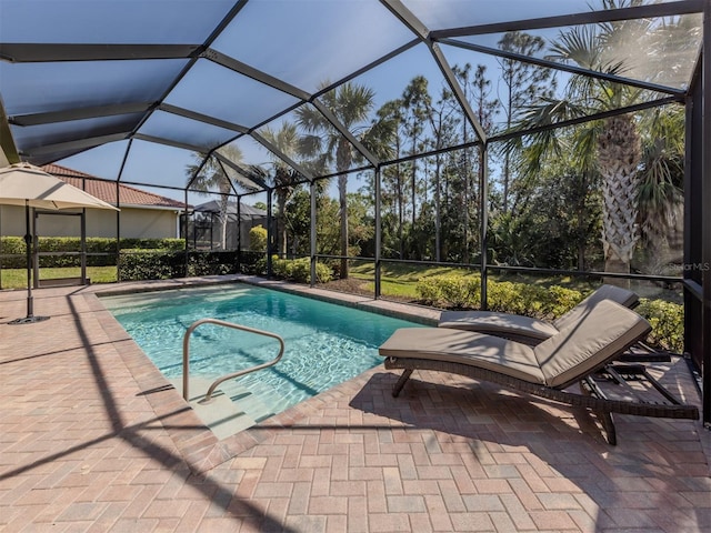 pool with a patio area and glass enclosure