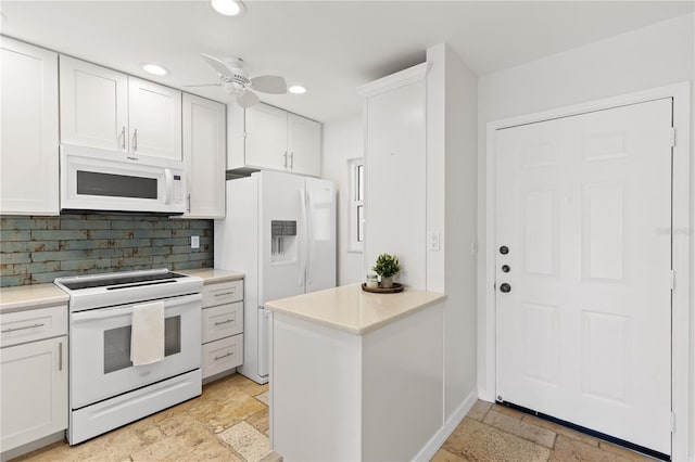 kitchen with white cabinets, white appliances, and light countertops