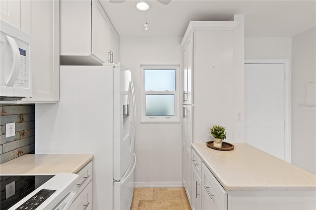 kitchen featuring white appliances, white cabinetry, and light countertops