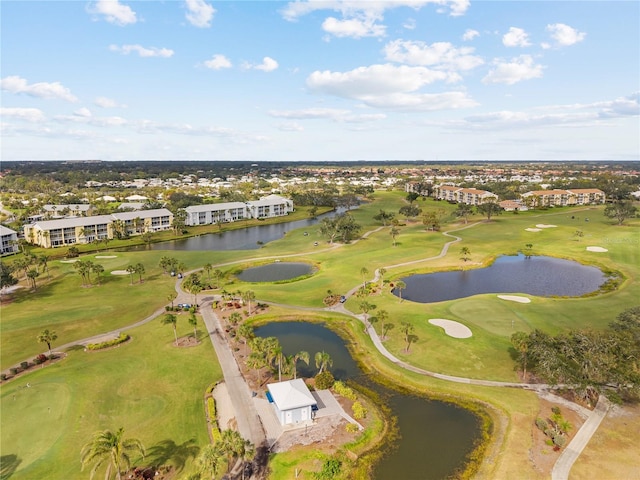 birds eye view of property with a water view and golf course view