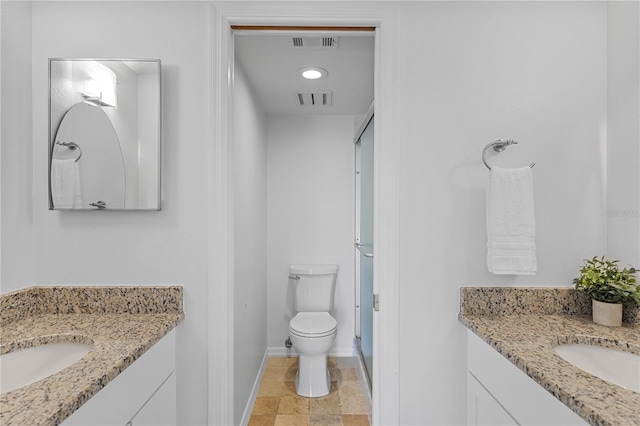 bathroom with toilet, baseboards, visible vents, and a sink