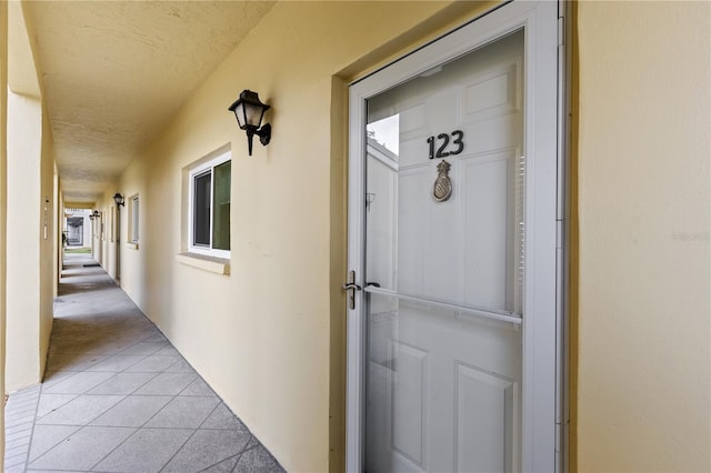 entrance to property featuring stucco siding