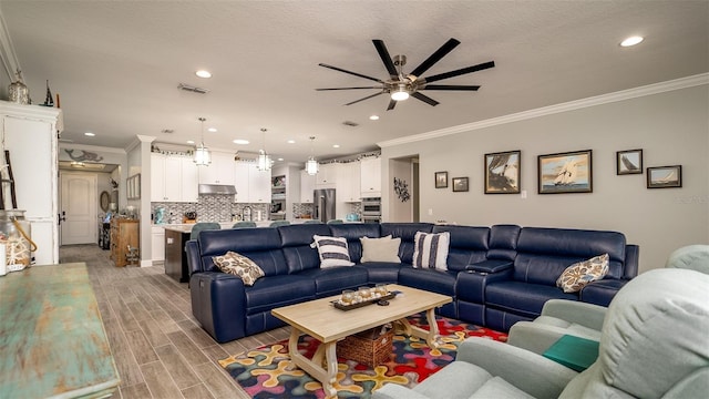 living room with recessed lighting, visible vents, a textured ceiling, and wood finish floors