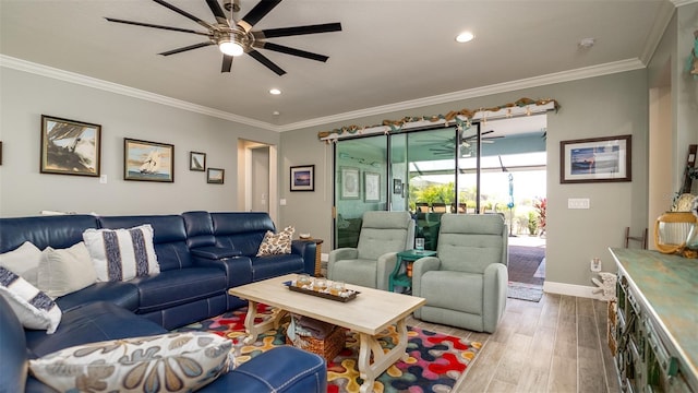 living area featuring ceiling fan, crown molding, baseboards, and wood finished floors