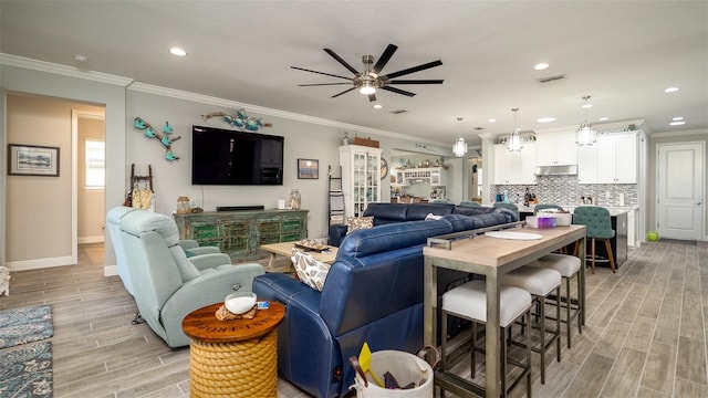 living area featuring crown molding, recessed lighting, visible vents, wood tiled floor, and ceiling fan