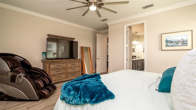 bedroom featuring visible vents, crown molding, ensuite bathroom, and wood finished floors