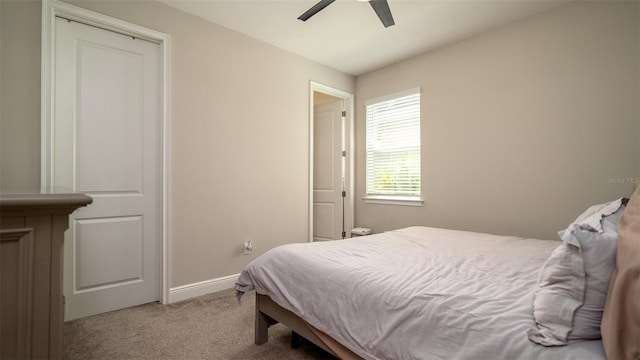 carpeted bedroom with baseboards and a ceiling fan