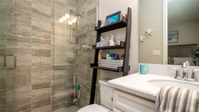 full bathroom with toilet, a stall shower, and vanity