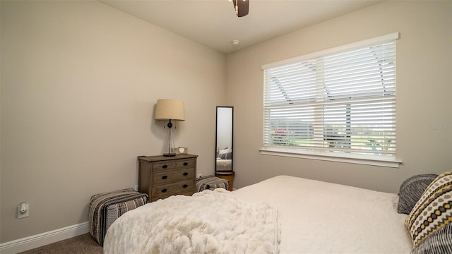 carpeted bedroom featuring ceiling fan and baseboards