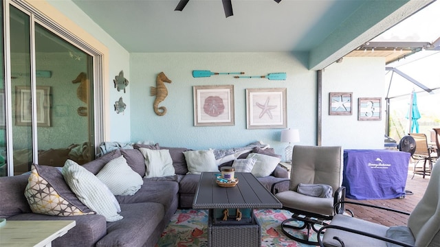 living room featuring a sunroom and ceiling fan