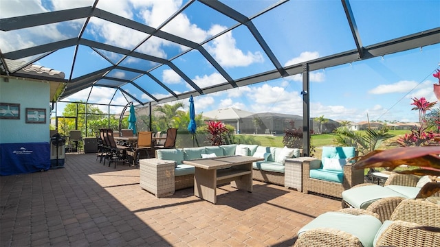 view of patio / terrace featuring outdoor dining area, glass enclosure, and an outdoor hangout area