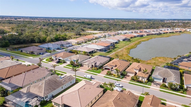 birds eye view of property featuring a water view and a residential view