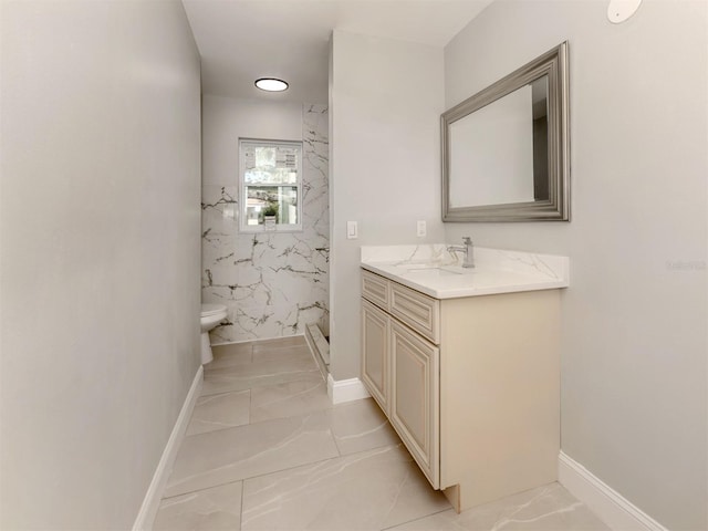 full bath with toilet, marble finish floor, a shower stall, and vanity