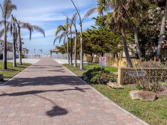 view of home's community with decorative driveway