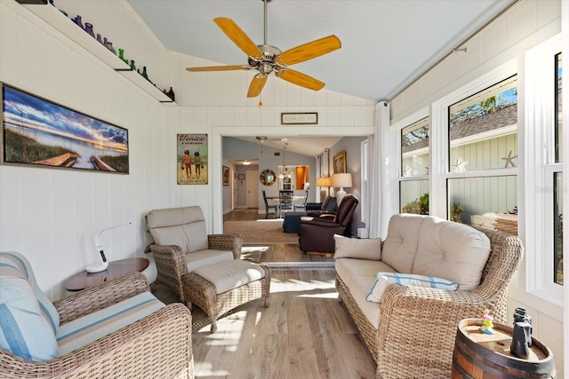 sunroom / solarium with lofted ceiling, a ceiling fan, and a wealth of natural light