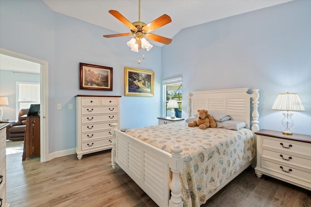 bedroom featuring ceiling fan, high vaulted ceiling, wood finished floors, and baseboards