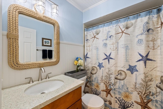 bathroom with crown molding, curtained shower, toilet, wainscoting, and vanity