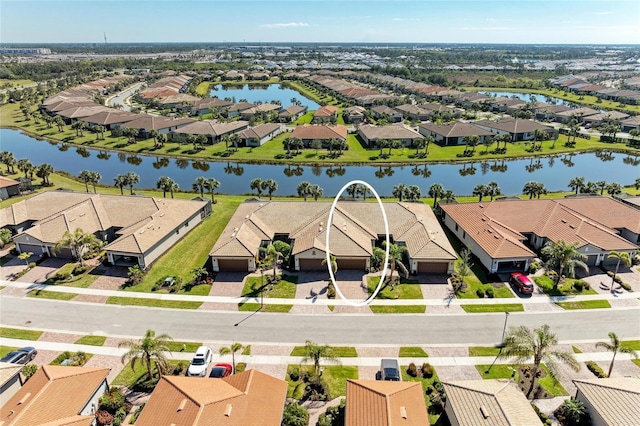 drone / aerial view with a water view and a residential view