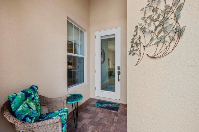 property entrance with stucco siding