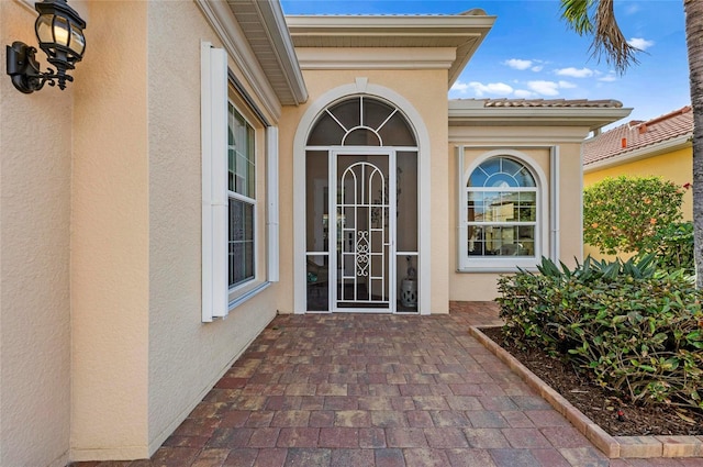 doorway to property with stucco siding