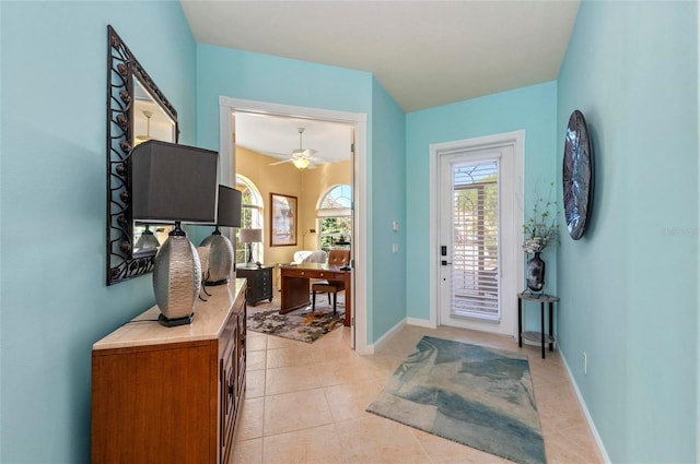 foyer entrance featuring light tile patterned floors and baseboards