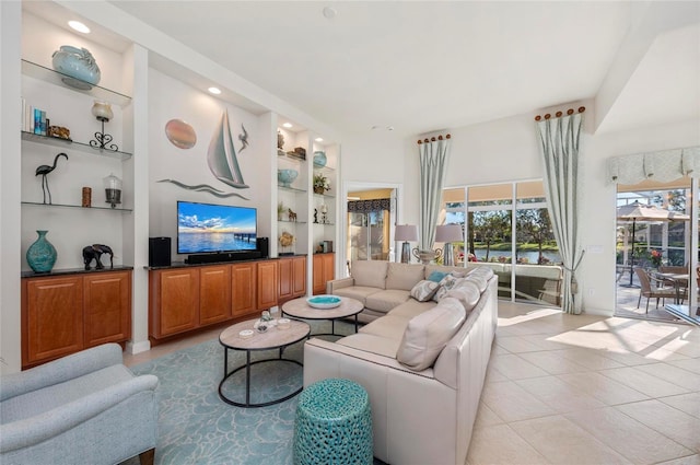 living area featuring a healthy amount of sunlight, light tile patterned flooring, and built in features