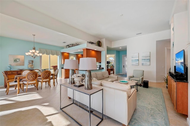 living room with baseboards, a healthy amount of sunlight, light tile patterned flooring, and a notable chandelier